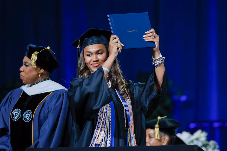 A graduate reacts after receiving her diploma during the Spelman College commencement ceremony at the Georgia International Convention Center in College Park on Sunday, May 17, 2026. (Miguel Martinez/AJC)