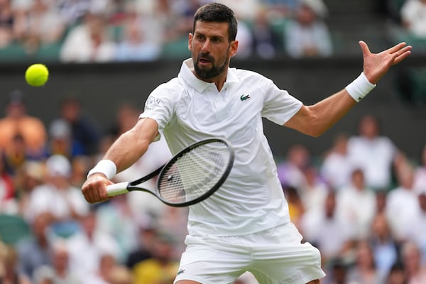 Novak Djokovic of Serbia returns to Miomir Kecmanovic of Serbia during a third round men's singles match at the Wimbledon Tennis Championships in London, Saturday, July 5, 2025. (AP Photo/Kirsty Wigglesworth)