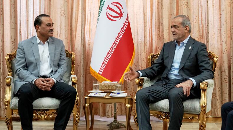 In this photo released by the Iranian Presidency Office, President Masoud Pezeshkian, right, speaks with Pakistan's Army Chief Field Marshal Gen. Asim Munir in Tehran, Iran, Saturday, May 23, 2026. (Iranian Presidency Office via AP)