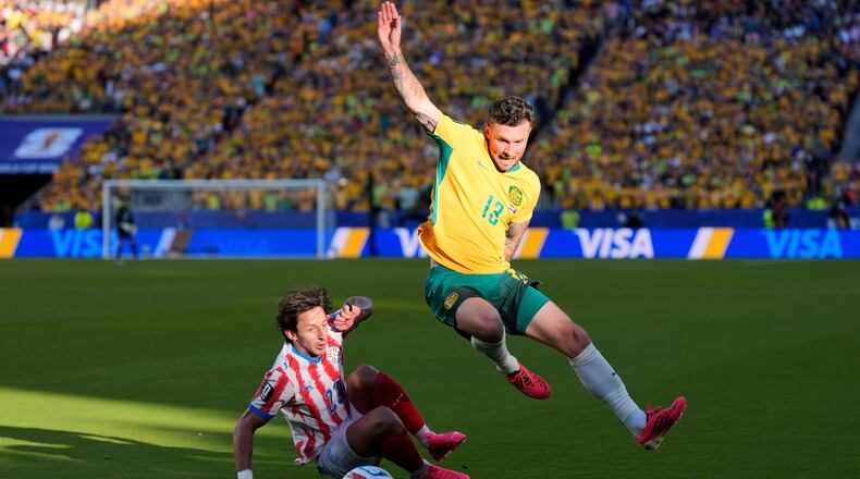 Australia's Aiden O'Neill (13) battles for the ball with Paraguay's Matias Galarza (23) during the World Cup Group D soccer match between Paraguay and Australia in Santa Clara, Calif., near San Francisco, Thursday, June 25, 2026. (AP Photo/Eugene Hoshiko)