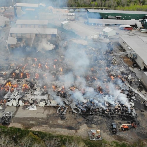 In this photo provided by the Maine State Fire Marshal, flames burn through Robbins Lumber following an explosion, May 15, 2026, in Searsmont, Maine. (Maine State Fire Marshal via AP)