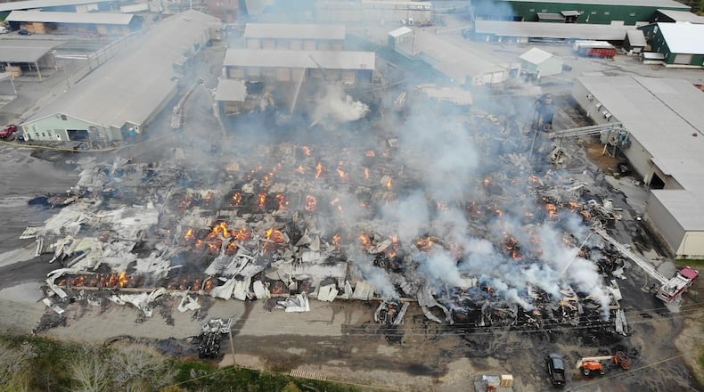 In this photo provided by the Maine State Fire Marshal, flames burn through Robbins Lumber following an explosion, May 15, 2026, in Searsmont, Maine. (Maine State Fire Marshal via AP)
