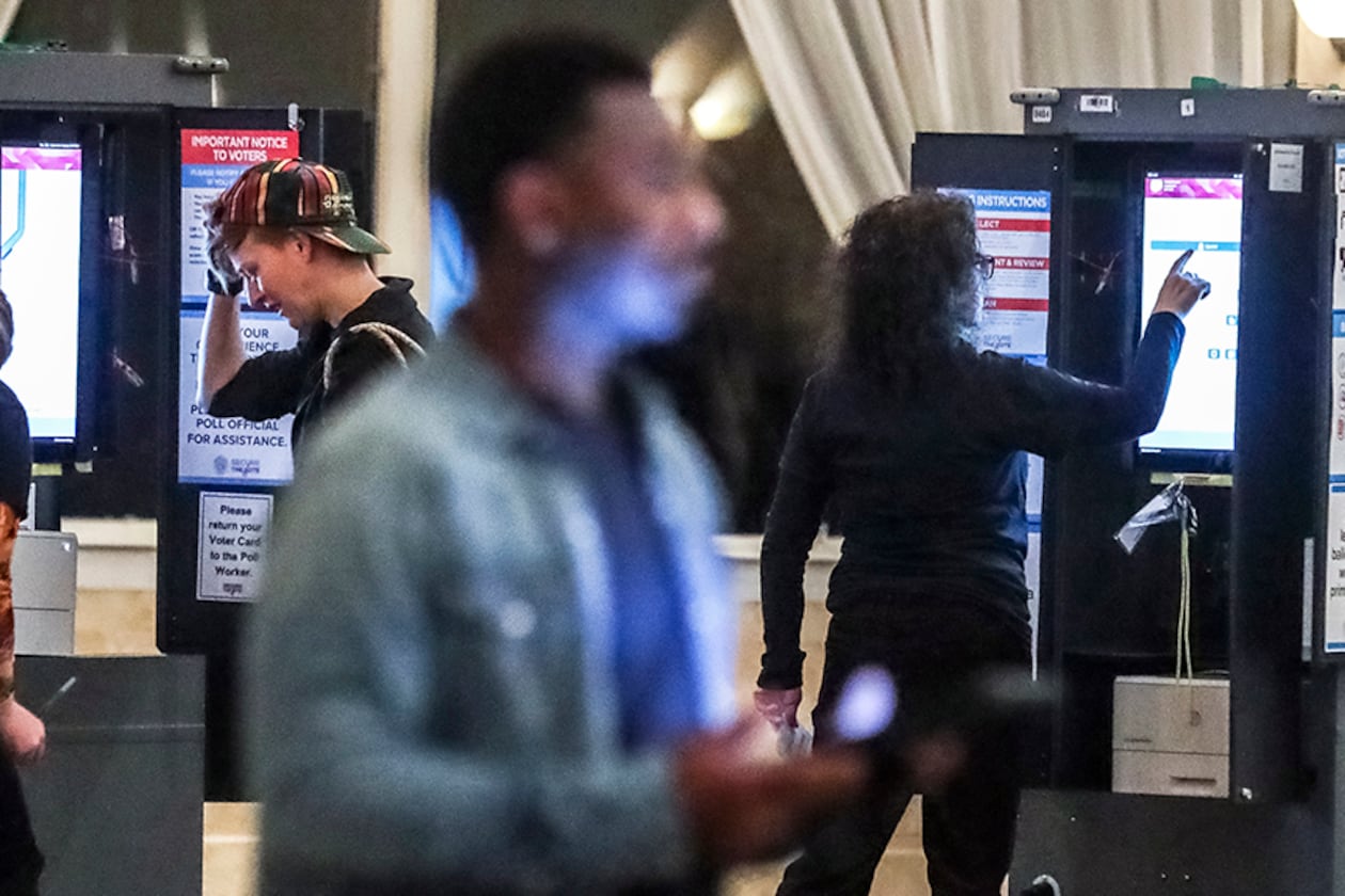 December 6, 2022 Atlanta: Poll workers (left to right) Alexandra Almeter, Gamble Everett, Erik Coleman and Sarah Zaslaw prepare the voting machines before the polls opened on Tuesday, Dec. 6, 2022 at the Park Tavern located at 500 10th Street NE in Atlanta. ItÕs been a marathon, not a sprint, for Georgia voters to settle on a long-term replacement for the late U.S. Sen. Johnny Isakson, who resigned from the Senate in 2019 amid ongoing health concerns. One gubernatorial appointment and five statewide elections later, TuesdayÕs U.S. Senate runoff election in Georgia will finally decide who will represent Georgia in the Senate for a full, six-year term. In WalkerÕs final speech at the GovernorÕs Gun Club, he told a small crowd, ÒThe best thing IÕve ever done, including the Heisman Trophy, and the Horatio Alger award, the best thing IÕve ever done is run for office right here.Ó Late Monday night, Warnock Tweeted a final message. ÒIÕve said it before and IÕll say it again, I canÕt have Herschel Walker representing my mama.Ó Most of the runoff polling put Warnock, the Democratic incumbent, slightly ahead of, but statistically tied with his Republican challenger. (John Spink / John.Spink@ajc.com)