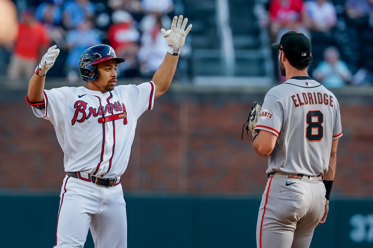 Braves designated hitter Drake Baldwin (left) celebrates after hitting a double as San Francisco Giants first baseman Bryce Eldridge stands by on Monday, Aug. 31, 2026, in Atlanta. The numbers overwhelmingly favor the Braves to make the playoffs. (Erik S. Lesser/AP)