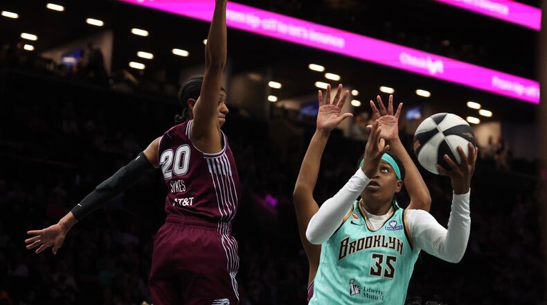 New York Liberty center Jonquel Jones (35) goes up for a shot against Toronto Tempo guard Brittney Sykes (20) during the first half of a WNBA basketball game, Wednesday, June 3, 2026, in New York. (AP Photo/Heather Khalifa)