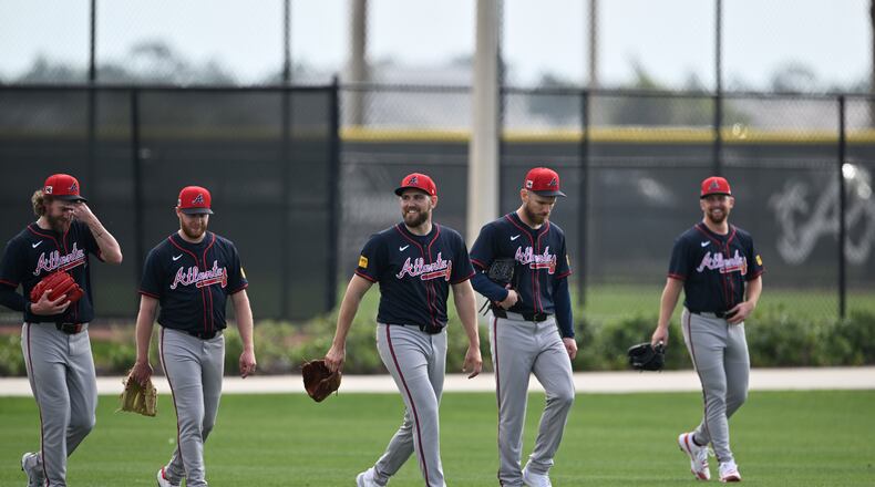 Atlanta Braves pitcher Dylan Lee (center) smiles as he walks with teammates during spring training workouts at CoolToday Park, Friday, February 14, 2025, North Port, Florida. (Hyosub Shin / AJC)