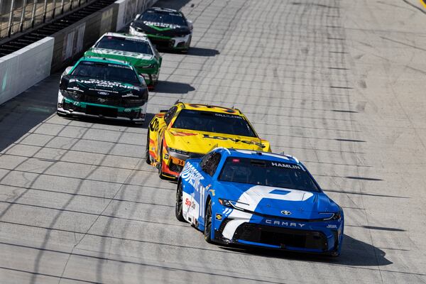 Denny Hamlin (11) leads Todd Gilliland (34), Chris Buescher (17), and others during a NASCAR Cup Series auto race, Sunday, April 13, 2025, in Bristol, Tenn. (AP Photo/Wade Payne)