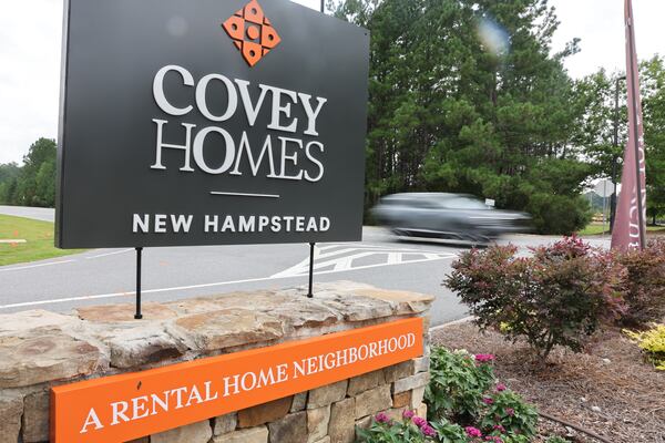 A car drives past a sign for a new development in New Hampstead in Savannah on Aug. 1, 2026. (Arvin Temkar/AJC)