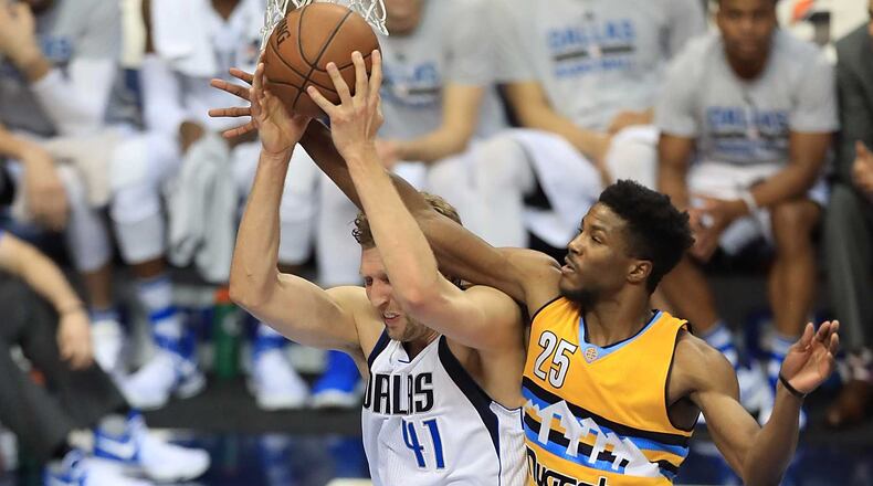 Malik Beasley (25) challenges Dirk Nowitzki's shot on April 11 in Dallas.
