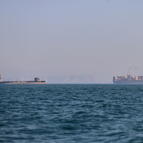 A container ship, right, and a cargo vessel are seen in the Strait of Hormuz off Bandar Abbas, Iran, Wednesday, June 17, 2026. (Amirhosein Khorgooi/ISNA via AP)