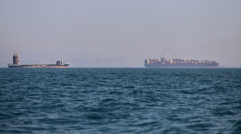A container ship, right, and a cargo vessel are seen in the Strait of Hormuz off Bandar Abbas, Iran, Wednesday, June 17, 2026. (Amirhosein Khorgooi/ISNA via AP)