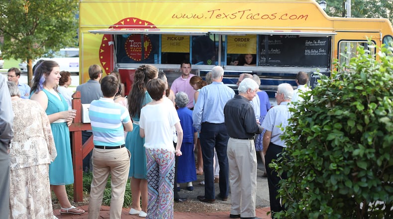 Customers line up to get some Tex's Taco food truck offerings.