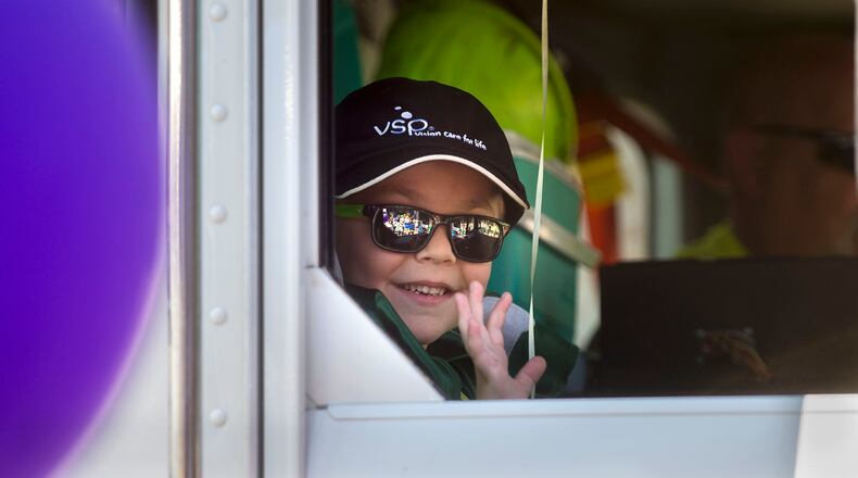 Six-year-old Ethan Dean, who was diagnosed with cystic fibrosis at two weeks old, rides in a waste truck as his wish to be a garbage man come true for a day in Sacramento, Calif., on Tuesday, July 26, 2016. Thanks to the Make-A-Wish Foundation, he got to experience what it's like to be a garbage truck driver, riding in a real garbage truck through downtown Sacramento, collecting trash and recyclables, just like he's always wanted. (Eli Hiller/Sacramento Bee via AP)