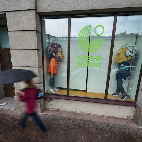 A person walks past figures depicting Johann Wolfgang Goethe, right, and Russian poet Alexander Pushkin installed in the window of the Goethe-Institut, Germany's cultural center in St. Petersburg, Russia, Thursday, Sept. 3, 2026. (AP Photo/Dmitri Lovetsky)