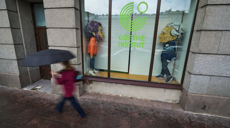 A person walks past figures depicting Johann Wolfgang Goethe, right, and Russian poet Alexander Pushkin installed in the window of the Goethe-Institut, Germany's cultural center in St. Petersburg, Russia, Thursday, Sept. 3, 2026. (AP Photo/Dmitri Lovetsky)