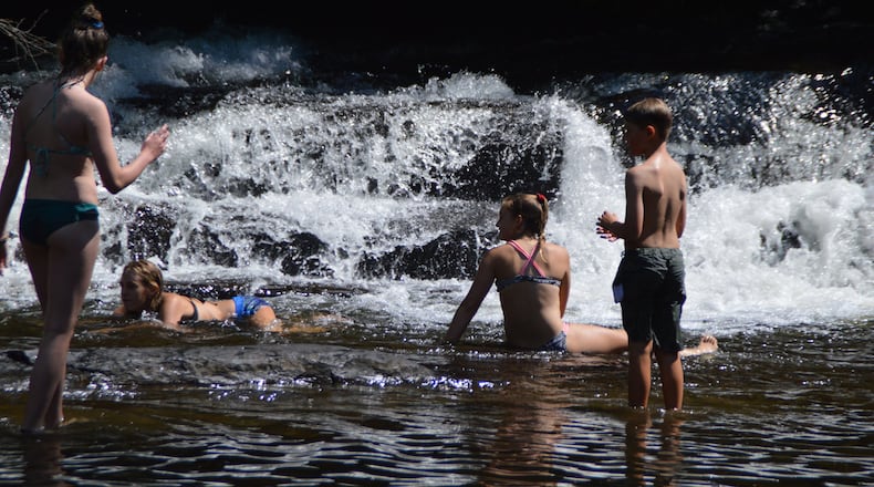 Locals enjoy a swimming break near one of the many waterfalls in North Carolina’s Transylvania County. (Myscha Theriault/TNS)