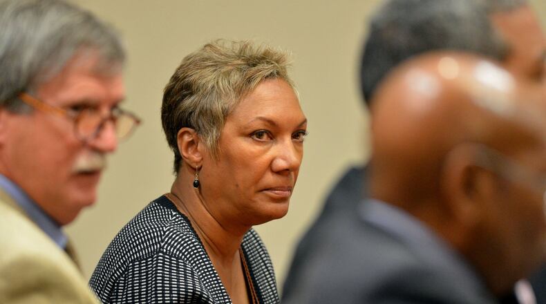 Pat Reid, co-defendant with former Dekalb County School Superintendent Crawford Lewis looks towards Lewis just before he plead guilty to obstruction of a law enforcement officer, a misdemeanor, in Dekalb County Superior Court before Judge Cynthia Becker Wednesday, October 16, 2013. Lewis was in court with co-defendants, Pat Reid and Tony Pope.