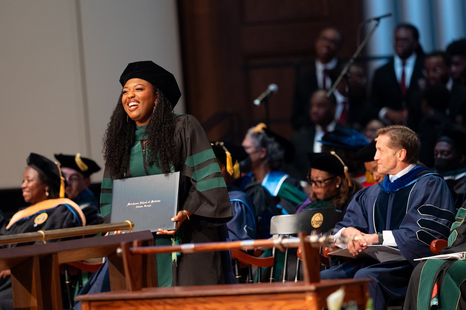 Dr. Mari Chiles smiles at her family as she receives her diploma during the Morehouse School of Medicine graduation ceremony on Saturday, May 16, 2026, in Atlanta. (Ben Gray for the AJC)