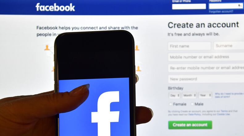 Some users say Facebook is posting their old photos like new ones and without their permission. (Photo by Carl Court/Getty Images)