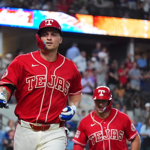 Texas Rangers' Corey Seager, center, jogs to the dugout after hitting a home run during the sixth inning of a baseball game against the Cleveland Guardians, Friday, June 5, 2026, in Arlington, Texas. (AP Photo/LM Otero)