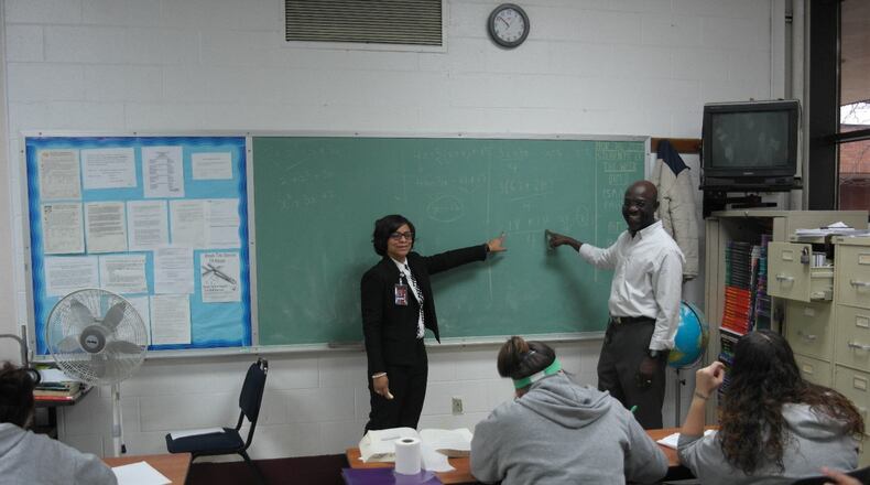 Victoria Jones,Sinclair women’s basketball coach and the site supervisor of the Sinclair education program at Dayton Correctional Institution. with math professor Kunle Akerele in a GED class at the prison (photo by Alan Mattingly/DCI) .