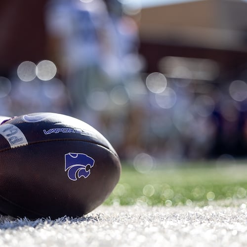 FILE - Kansas State footballs sit on the sideline before an NCAA college football game against Oklahoma State, Nov. 15, 2025, in Stillwater, Okla. (AP Photo/Mitch Alcala, File)