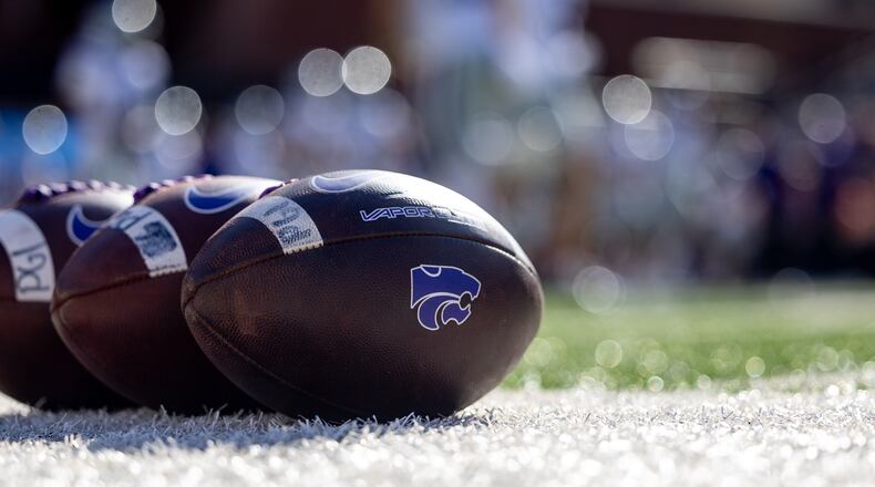 FILE - Kansas State footballs sit on the sideline before an NCAA college football game against Oklahoma State, Nov. 15, 2025, in Stillwater, Okla. (AP Photo/Mitch Alcala, File)