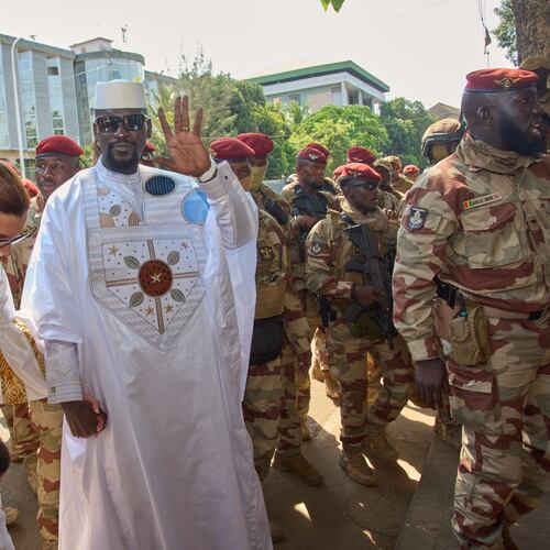 Guinea's President, Gen. Mamadi Doumbouya, arrives with his wife, Lauriane Doumbouya, to cast their votes in the presidential election in Conakry, Guinea, Sunday, Dec. 28, 2025. (AP Photo/Fode Toure)