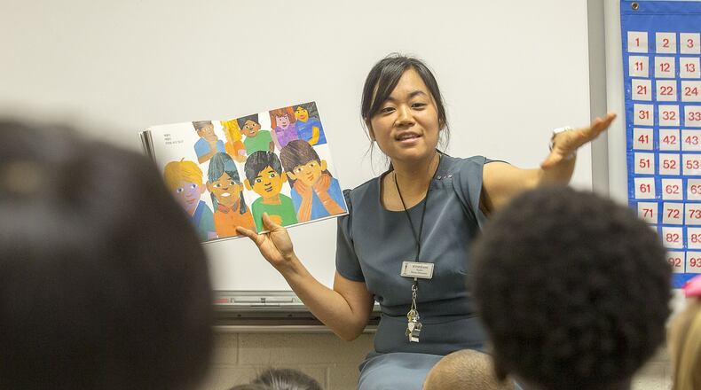 Korean dual language immersion program kindergarten teacher Jennifer Kim reads a Korean book to her students during the first day of school at Parsons Elementary School in Suwanee. Gwinnett County Public Schools’ Korean dual language immersion program is the first of this program offered in the state. (Alyssa Pointer/alyssa.pointer@ajc.com)