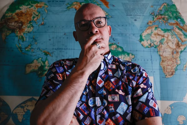 Mathew Palmer of Atlanta, a former Delta Air Lines employee, stands in front of a map marking the places he traveled during his time with the company.