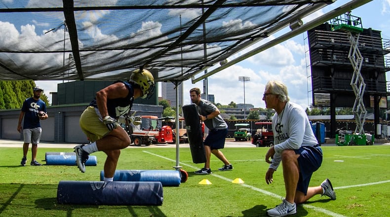 Georgia Tech defensive coordinator Ted Roof watches linebacker T.D. Roof (his son) go through footwork drills at practice.