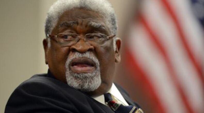 Former Dekalb School Board chairman Eugene Walker looks towards spectators as Dr Mark Elgart, President and CEO of AdvanceEd, parent company of SACS, testifies on the stand during the continuation of the reinstatement hearing for DeKalb school board member Eugene Walker, Friday June 28, 2013. Walker, who was removed with 5 other board members, says he was unfairly removed from his post by the governor. On Monday, Nov. 25, 2013, the Georgia Supreme Court unanimously upheld the law used by Gov. Nathan Deal to suspend members of the DeKalb County school board.