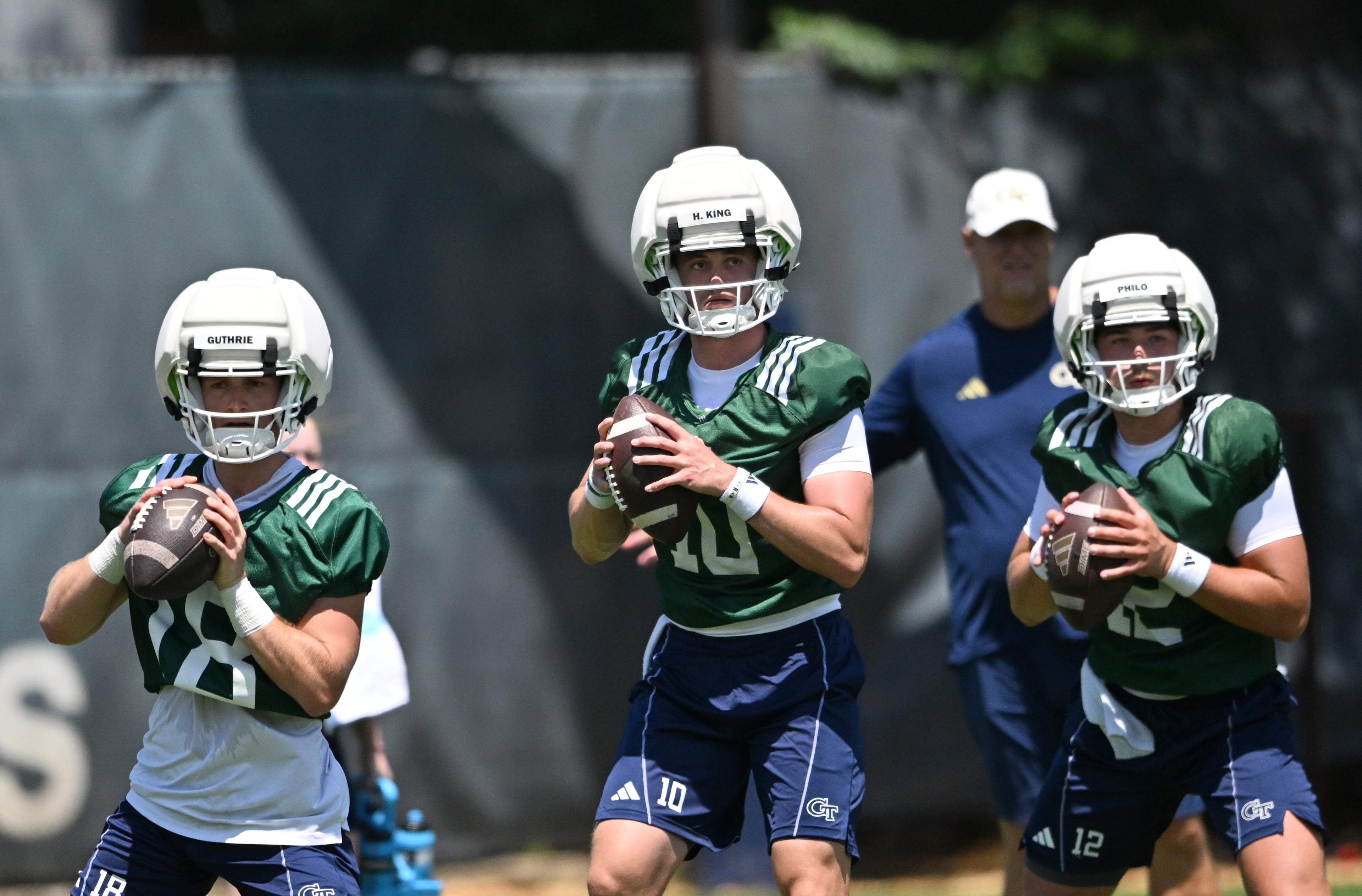 Georgia Tech quarterbacks (from left) Troy Stevenson IV, Haynes King and Aaron Philo participate in a drill during the first day of football practice at Rose Bowl Field and the Mary and John Brock Football Practice Facility, Tuesday, July 29, 2025, in Atlanta. (Hyosub Shin / AJC)