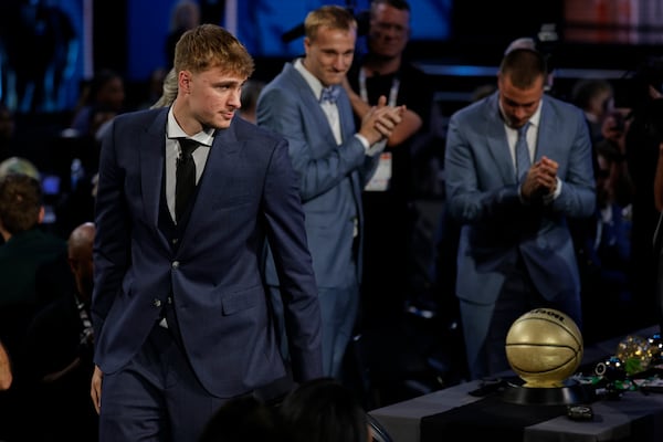 Cooper Flagg heads for the stage after being selected first overall by the Dallas Mavericks In the first round of the NBA basketball draft, Wednesday, June 25, 2025, in New York. (AP Photo/Adam Hunger)
