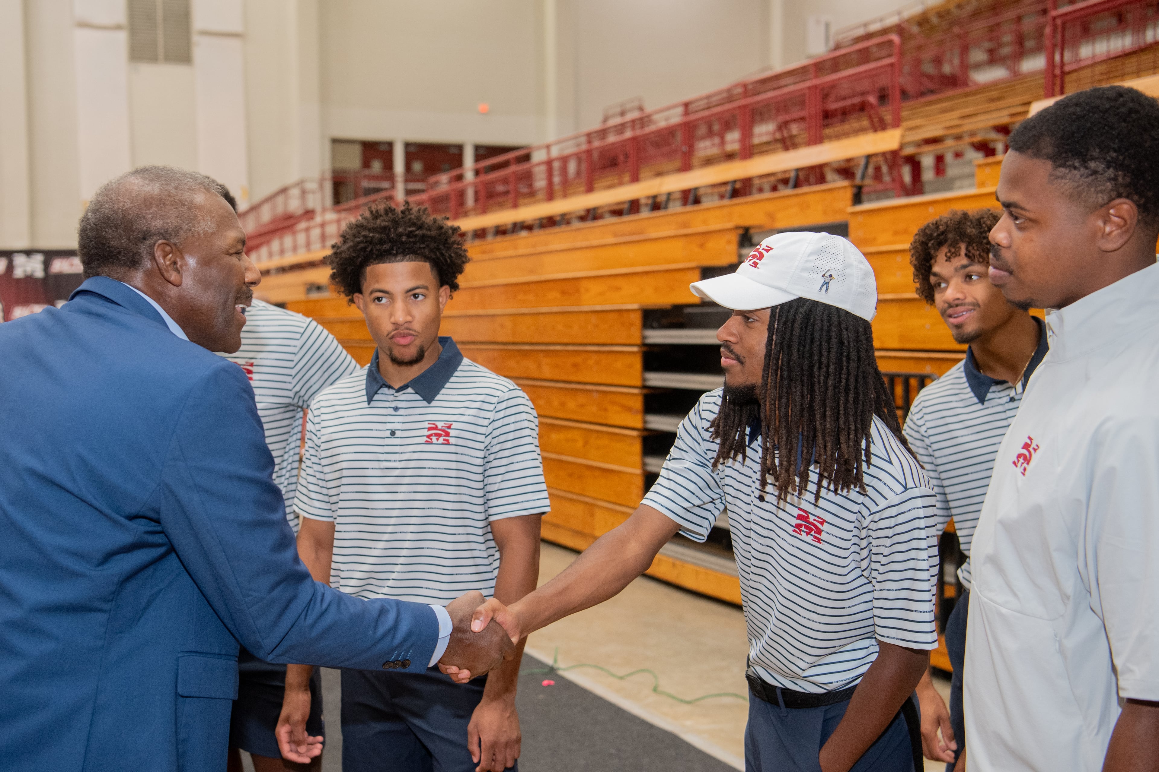 Ralph Stokes (left), VP of PGA Tour Superstore, greets Morehouse golfer Yusouf Gladney at the ribbon cutting for the new indoor practice facility. ( Kate Awtrey-King for the AJC)