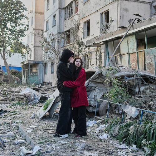 People react as they look at the site of Russian missile strike that hit a residential building in Kyiv, Ukraine, Tuesday, June 2, 2026. (AP Photo/Efrem Lukatsky)