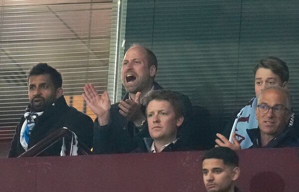 Britain's Prince William, centre, and Prince George, top right, support Aston Villa during the Champions League quarterfinal second leg soccer match between Aston Villa and Paris Saint-Germain at the Villa Park stadium, in Birmingham, England, Tuesday, April 15, 2025. (Nick Potts/PA via AP)