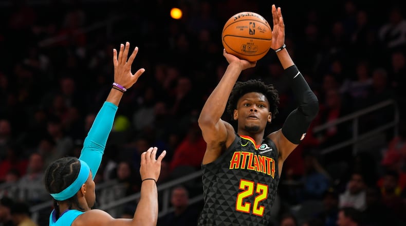 Hawks guard Cam Reddish shoots over Hornets guard Devonte' Graham. (AP Photo/John Amis)