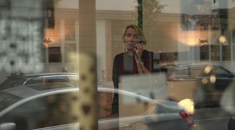 Véronique Bertrand, a funeral director, works the phones Sunday, June 28, 2026, at her office in Paris. (AP Photo/John Leicester)