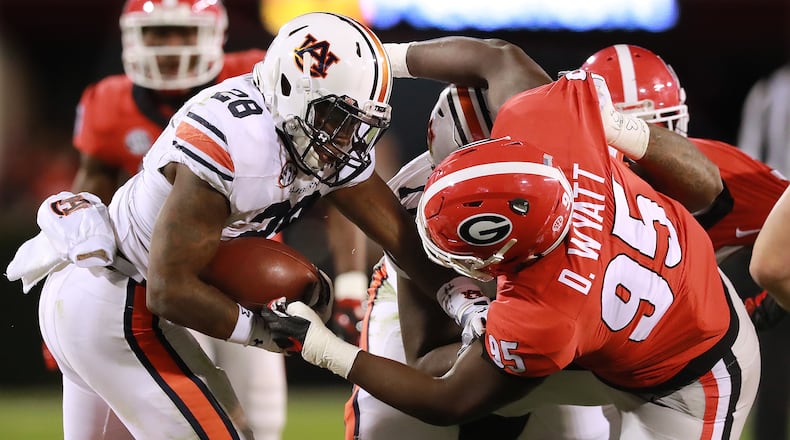 Georgia defensive tackle Devonte Wyatt tackles Auburn running back JaTarvious Whitlow during the first half in a NCAA college football game on Saturday, Nov. 10, 2018, in Athens. Curtis Compton/ccompton@ajc.com