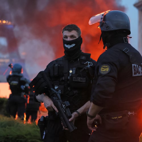 A car burns and fireworks explode as police watch PSG supporters celebrate in Paris, Saturday, May 30, 2026 after the Champions League final soccer match between Paris Saint-Germain and Arsenal that's being played in Budapest, PSG won the game. (AP Photo/Thomas Padilla)