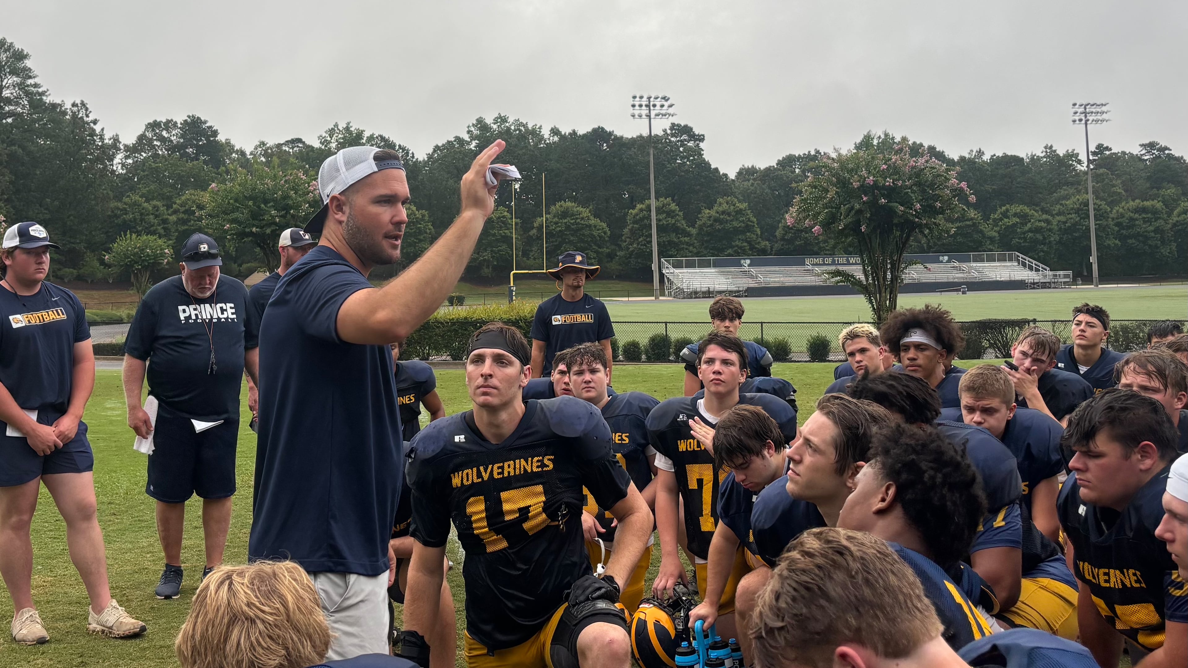 New Prince Avenue Christian School head coach Jon Richt addresses his team after a morning practice Wednesday. (Jack Leo/AJC).