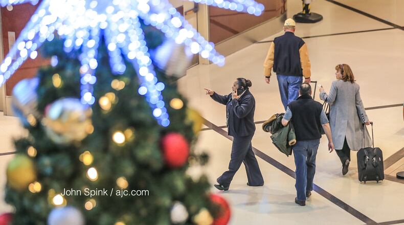 Travelers head through Hartsfield-Jackson International Airport in Atlanta on Friday as Christmas weekend begins.