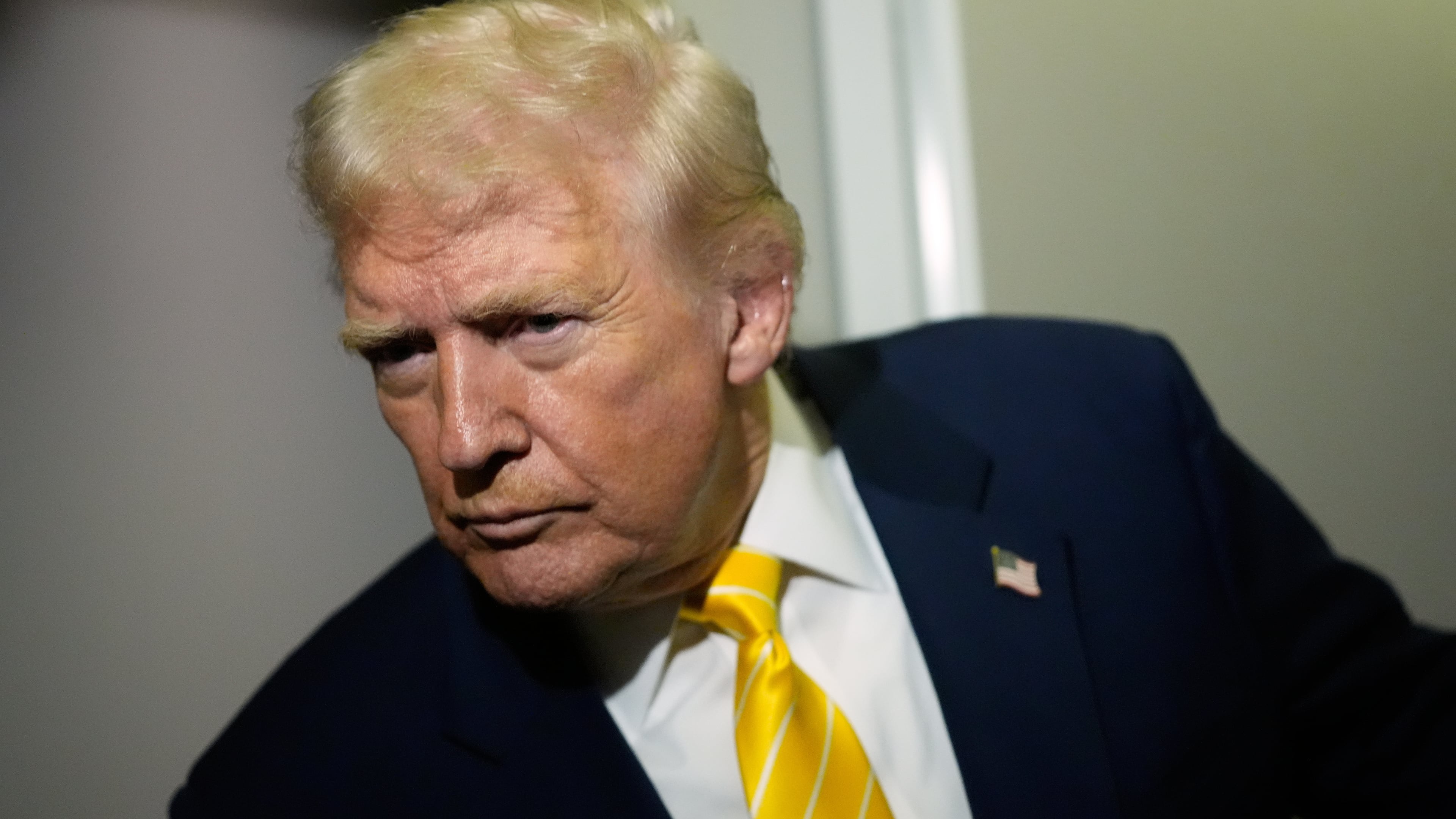 President Donald Trump speaks to reporters on Air Force One on his way to his Mar-a-Lago estate in Palm Beach, Fla., Friday, Nov. 14, 2025. (AP Photo/Manuel Balce Ceneta)