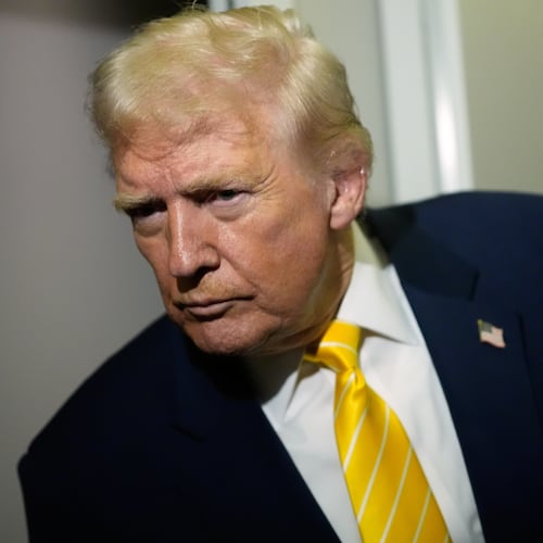 President Donald Trump speaks to reporters on Air Force One on his way to his Mar-a-Lago estate in Palm Beach, Fla., Friday, Nov. 14, 2025. (AP Photo/Manuel Balce Ceneta)