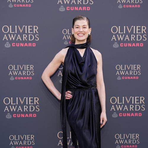 Rosamund Pike poses for photographers upon arrival at the Olivier Awards in London, England, Sunday, April 12, 2026. (Photo by Scott A Garfitt/Invision/AP)