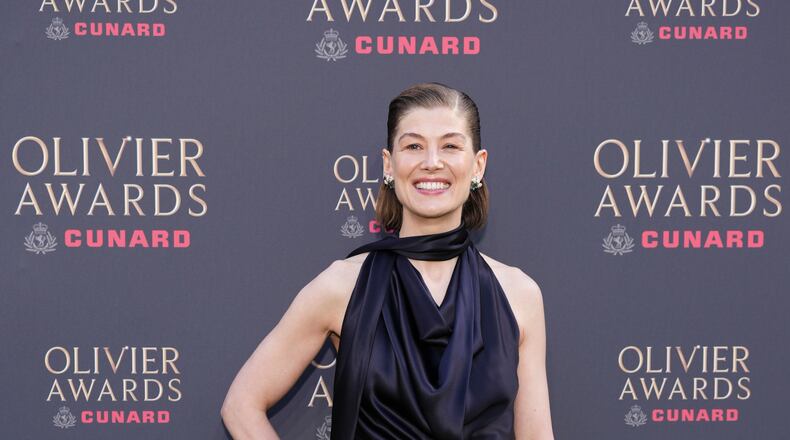 Rosamund Pike poses for photographers upon arrival at the Olivier Awards in London, England, Sunday, April 12, 2026. (Photo by Scott A Garfitt/Invision/AP)
