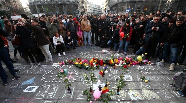 BRUSSELS, BELGIUM - People gathered to leave tributes at the Place de la Bourse following today's attacks on March 22, 2016 in Brussels, Belgium. (Photo by Carl Court/Getty Images)