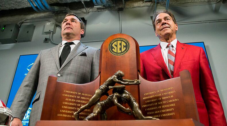 11/30/2018 -- Atlanta, Georgia -- University of Georgia head football coach Kirby Smart (left) and University of Alabama head coach Nick Saban (right) stand for a photo with the SEC Championship trophy during a press conference at Mercedes Benz Stadium, Friday, November 30, 2018. Georgia will play the University of Alabama in the 2018 SEC Championship game on Saturday (ALYSSA POINTER/ALYSSA.POINTER@AJC.COM)
