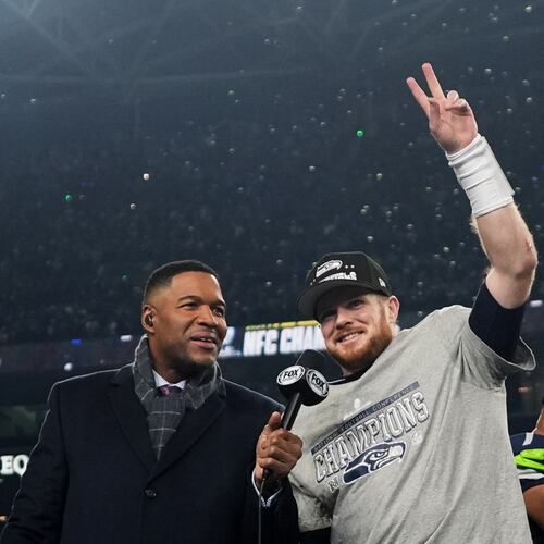 Seattle Seahawks quarterback Sam Darnold, celebrates next to Michael Strahan, left, after a win over the Los Angeles Rams in the NFC Championship NFL football game Sunday, Jan. 25, 2026, in Seattle. (AP Photo/Lindsey Wasson)